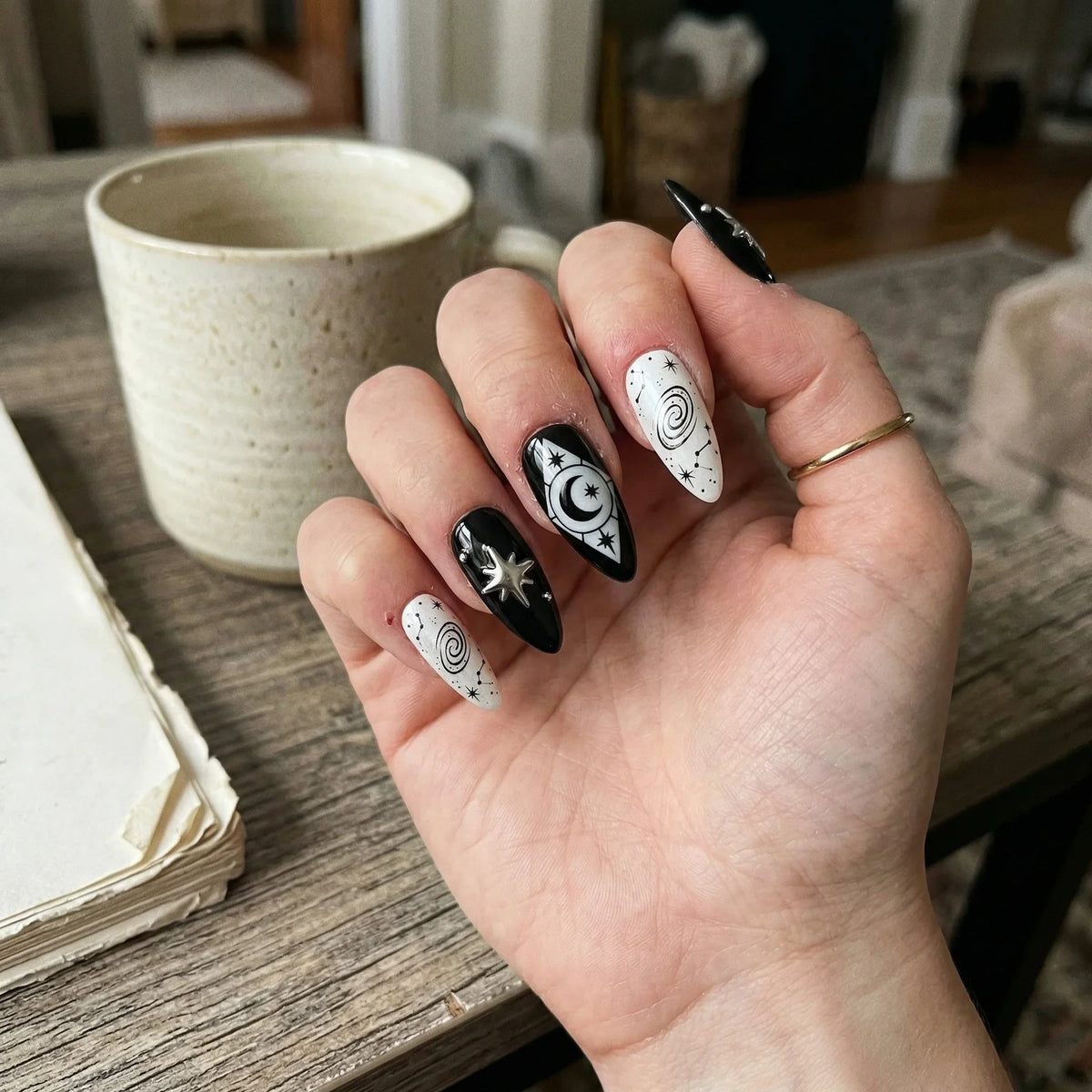 black hand painted stiletto medium press on nails spiral galaxy lifestyle 02