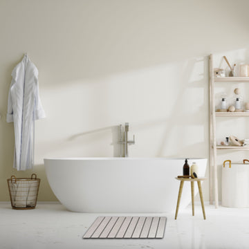 Modern bathroom featuring the best stone bath mat near a freestanding tub and organized shelves