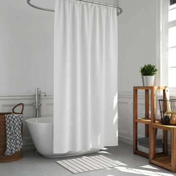 Bathroom with a white shower curtain, freestanding bathtub, and wooden shelf.