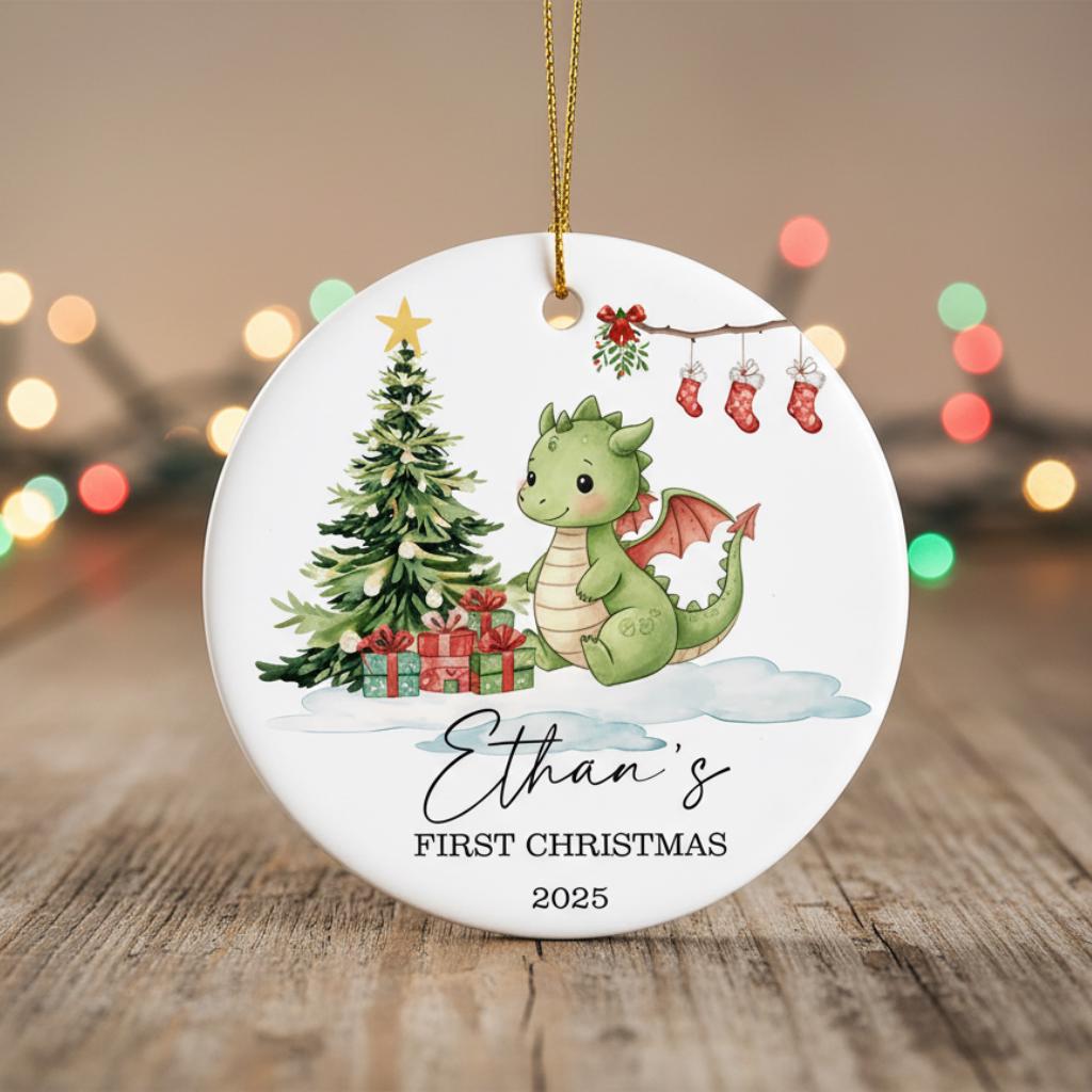 Christmas ornament with a dragon, tree, and presents on a wooden surface with blurred lights in the background.