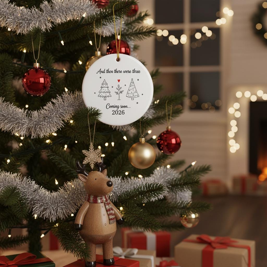Decorated Christmas tree with ornaments and a sign about a baby's arrival, surrounded by lights and presents.