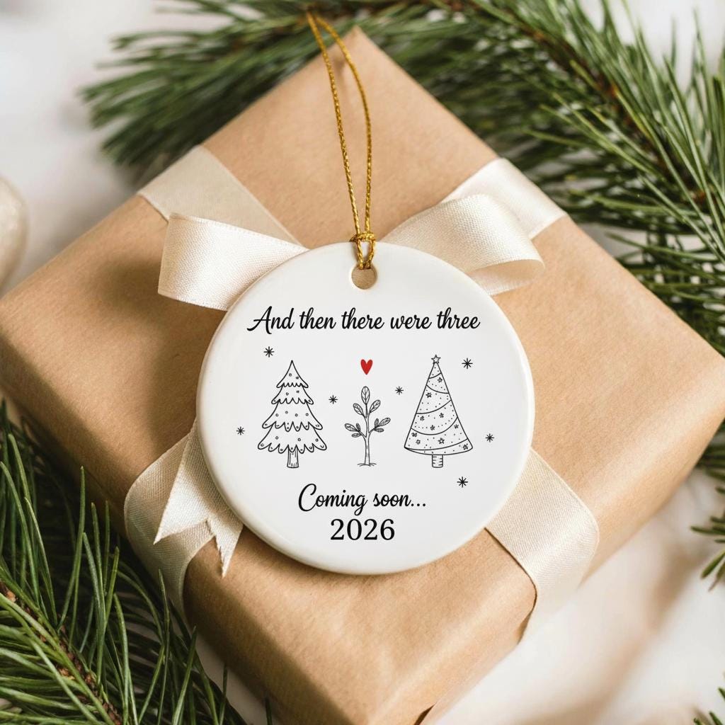 Christmas ornament with text and tree illustrations on a wrapped gift with gold ribbon.