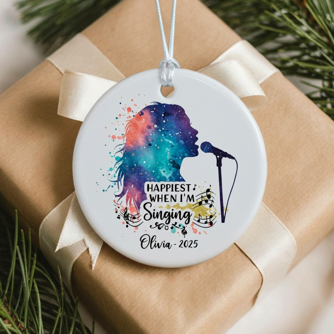 Decorative ornament with a colorful silhouette of a person singing, placed on a wrapped gift.