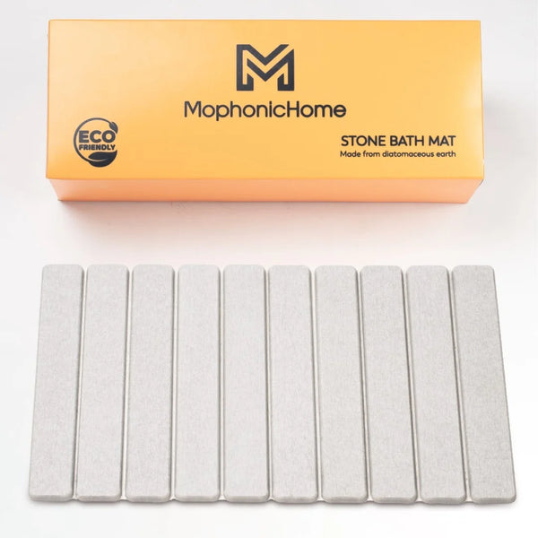 MophonicHome stone bath mat with packaging on a white background