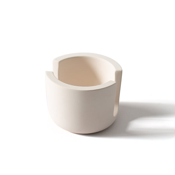 White diatomite sponge holder with a beige interior on a white background