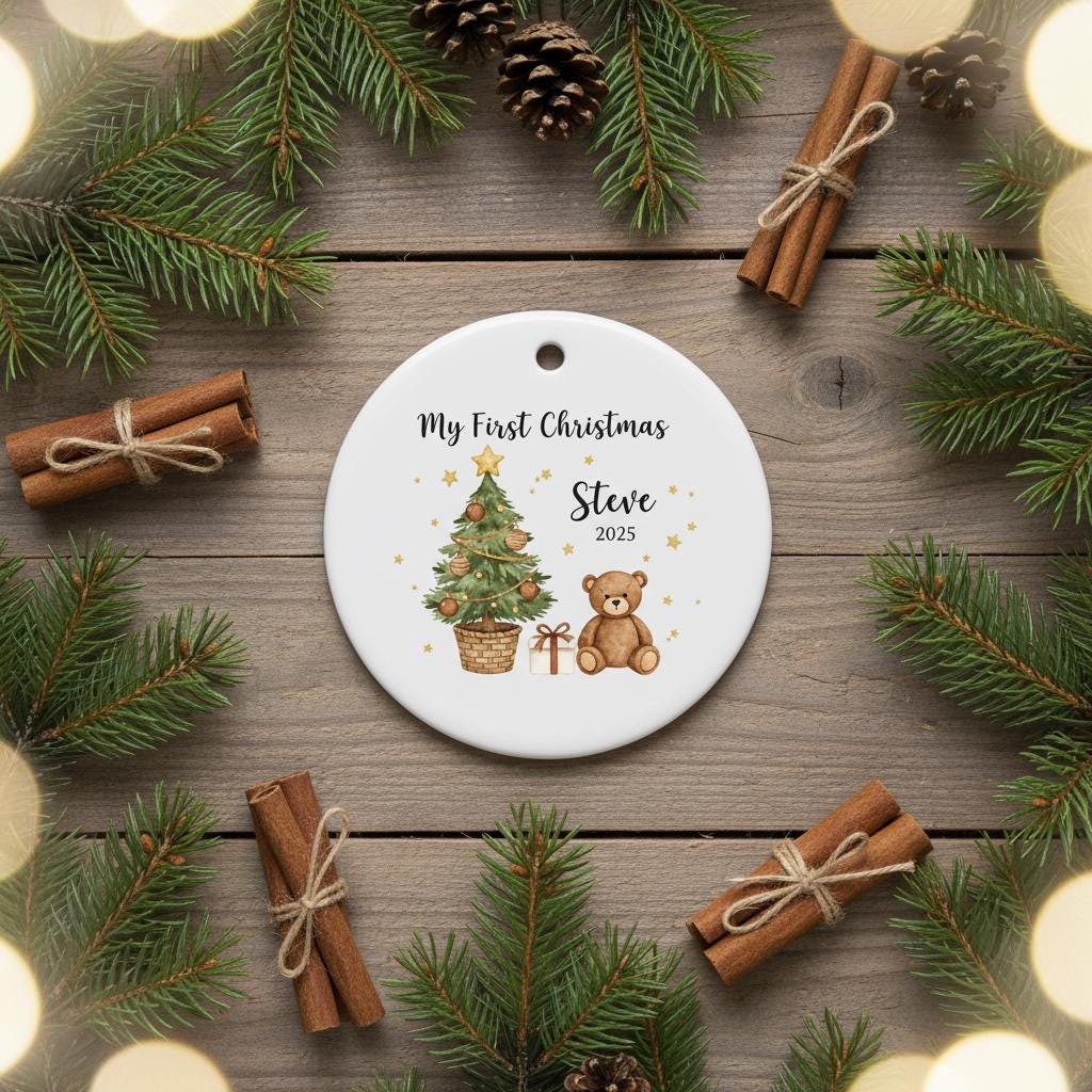 Personalized Christmas ornament with tree, teddy bear, and gift on a wooden background with pine branches and cinnamon sticks.