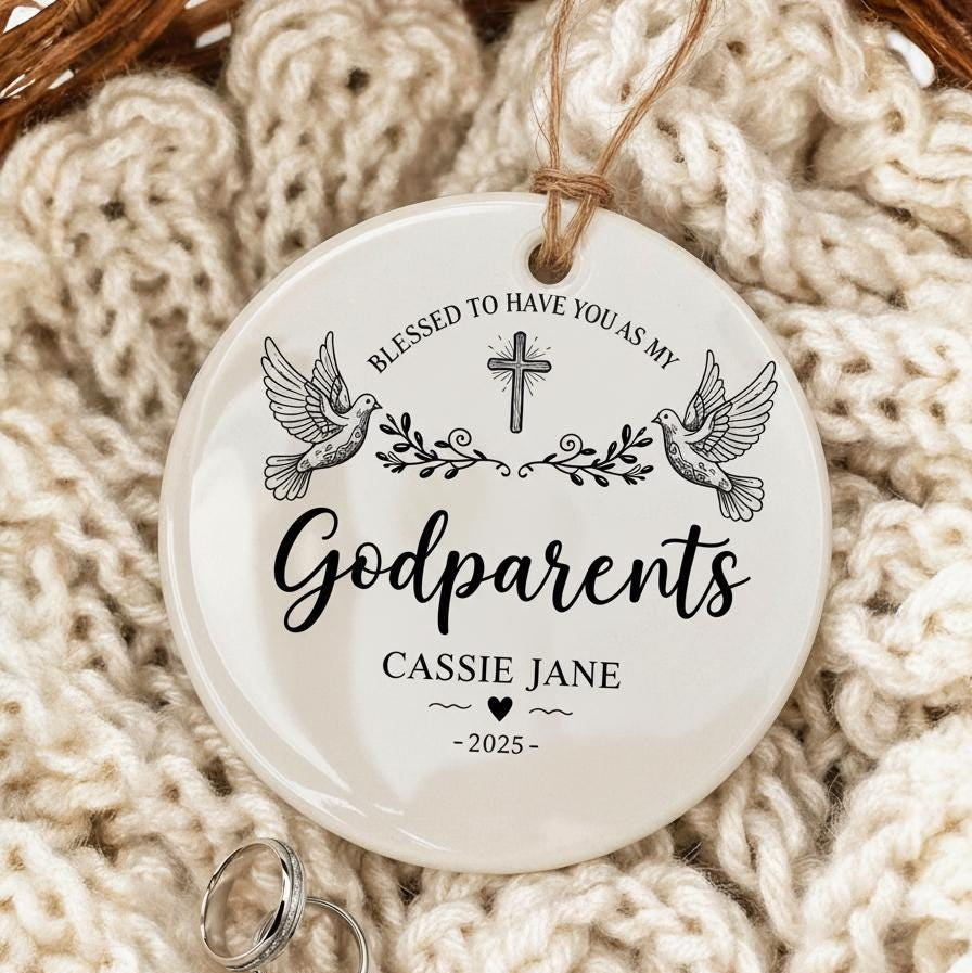 Round ceramic ornament with 'Godparents' text and design on a knitted surface