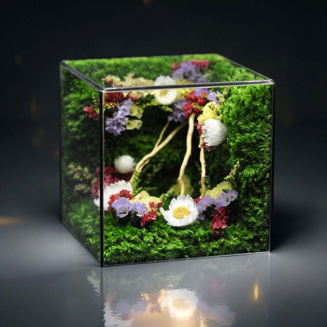 Decorative box with moss and colorful dried flowers on a white background