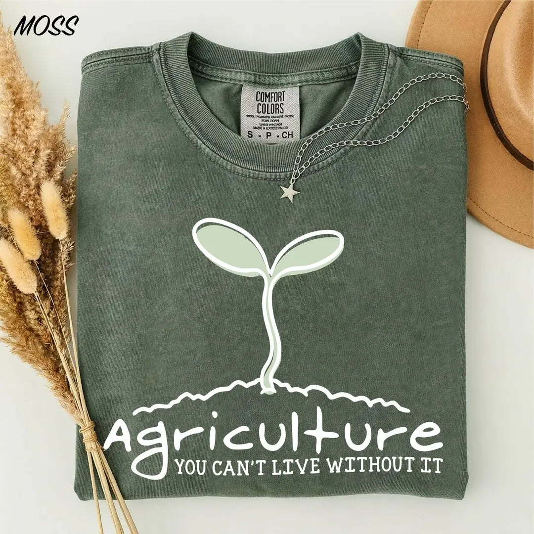 Moss Comfort Colors 1717 T-shirt featuring a sprout graphic and the words Agriculture, You Can't Live Without It.
