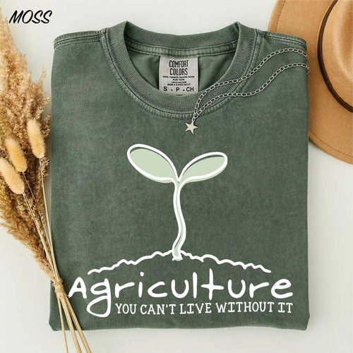 Moss Comfort Colors 1717 T-shirt featuring a sprout graphic and the words Agriculture, You Can't Live Without It.
