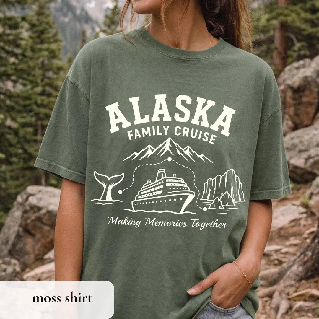 Woman in a Moss green Comfort Colors tee among rocks and pines, ivory Alaska Family Cruise, mountains, whale tail and ship