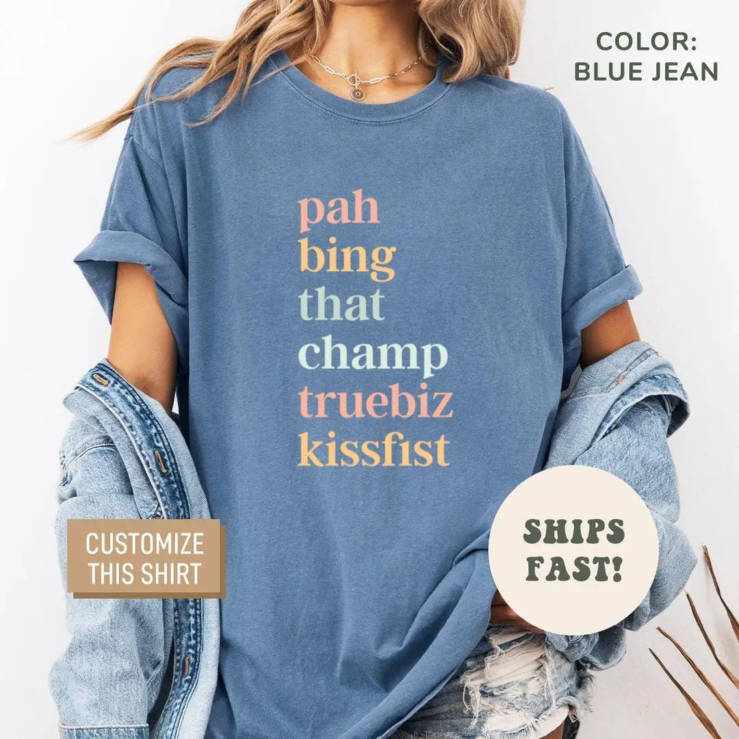 Woman in a Blue Jean Comfort Colors tee and a denim jacket, with pah bing that champ truebiz kissfist on the chest