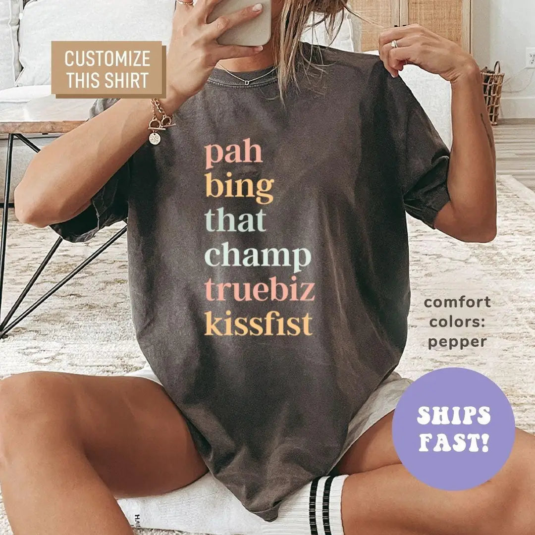 Woman in a Pepper Comfort Colors tee taking a mirror selfie, six stacked ASL slang words in multicolor serif