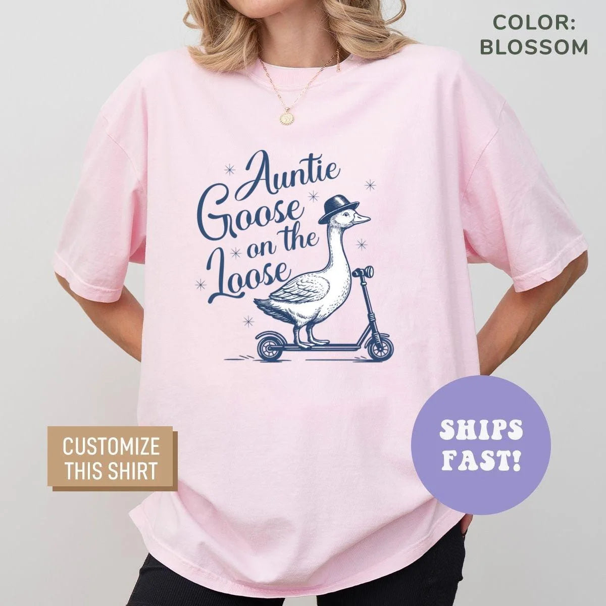 Woman in a Blossom pink Comfort Colors tee with a navy line-art goose on a scooter and Auntie Goose on the Loose