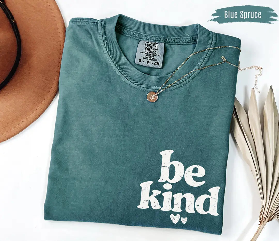 Blue Spruce Comfort Colors T-shirt with bold white 'be kind' inspirational design.