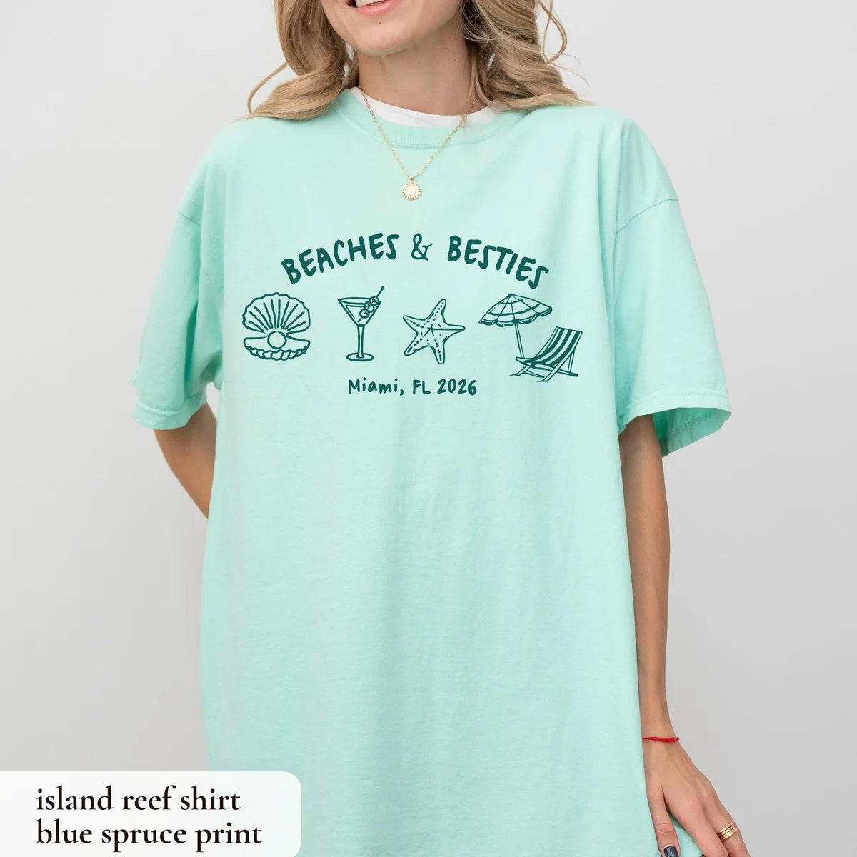 Woman in an Island Reef mint Comfort Colors tee with teal beaches and besties lettering and a row of beach icons
