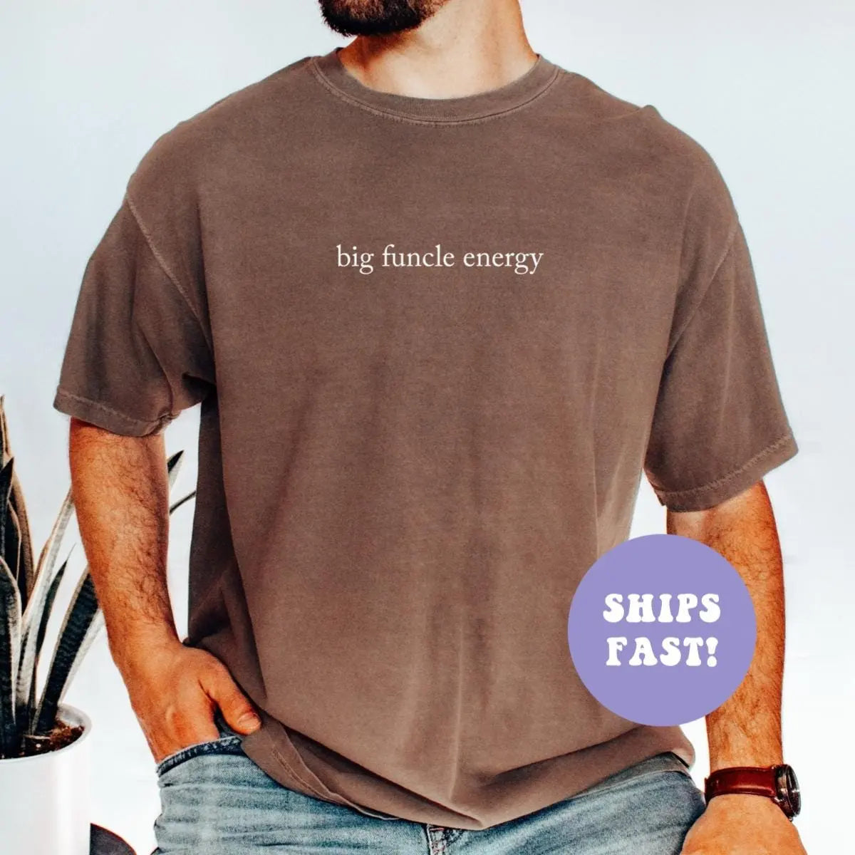 Man in an Espresso Comfort Colors tee and jeans with big funcle energy in light lowercase serif across the chest