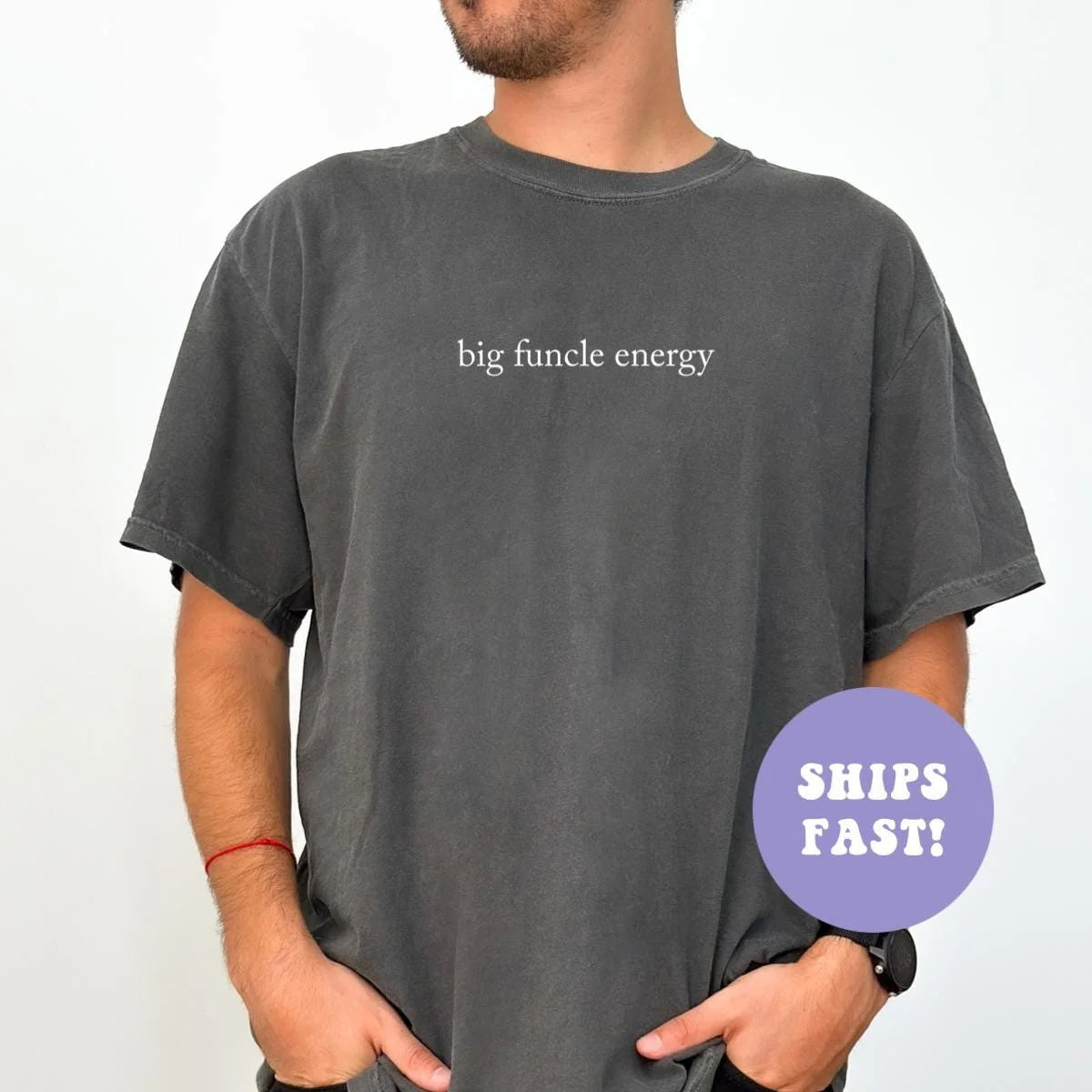 Man in a Pepper Comfort Colors tee, hands in pockets, with big funcle energy in small white serif letters