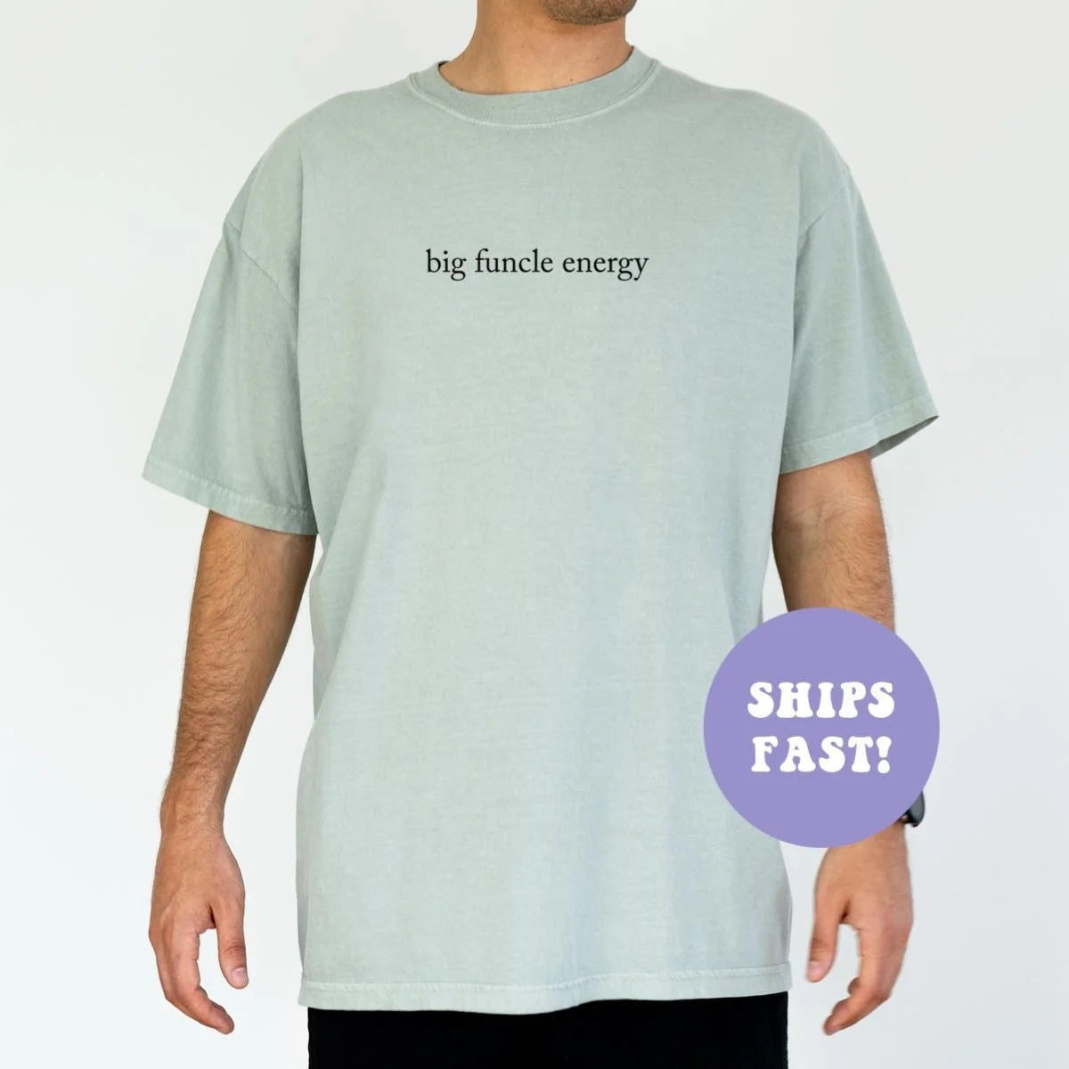 Man in a Seafoam Comfort Colors tee, arms at his sides, with big funcle energy in dark lowercase serif type