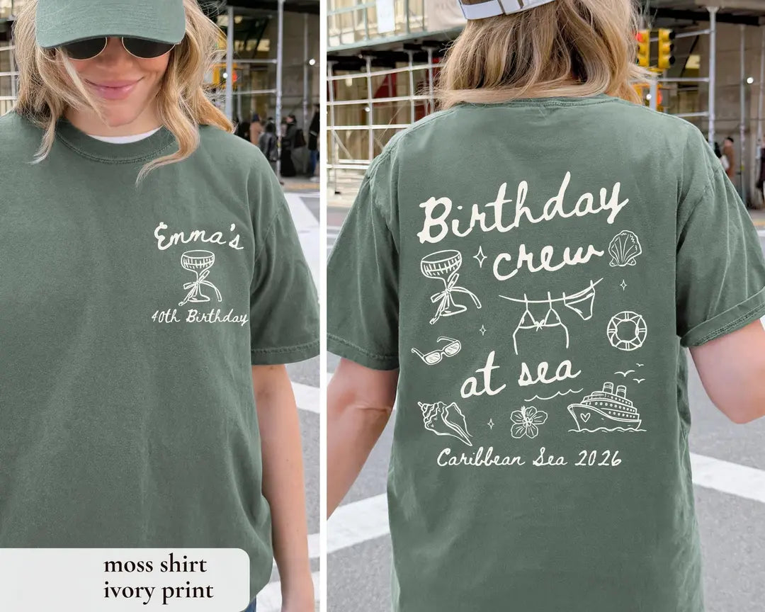 Woman in a Moss green Comfort Colors tee, front with an ivory goblet and Emma's, back with Birthday crew at sea