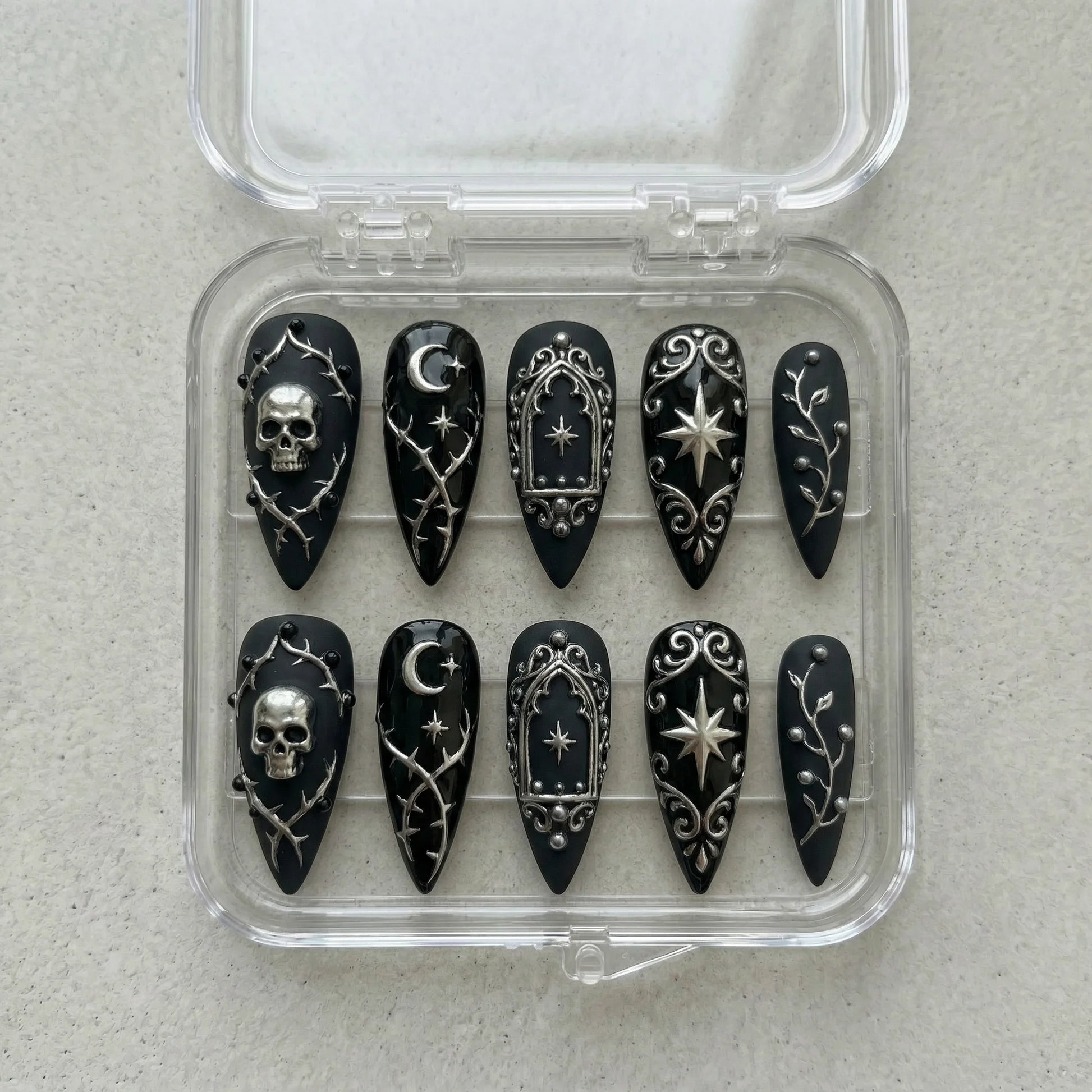 black hand painted halloween stiletto medium press on nails flat lay 01
