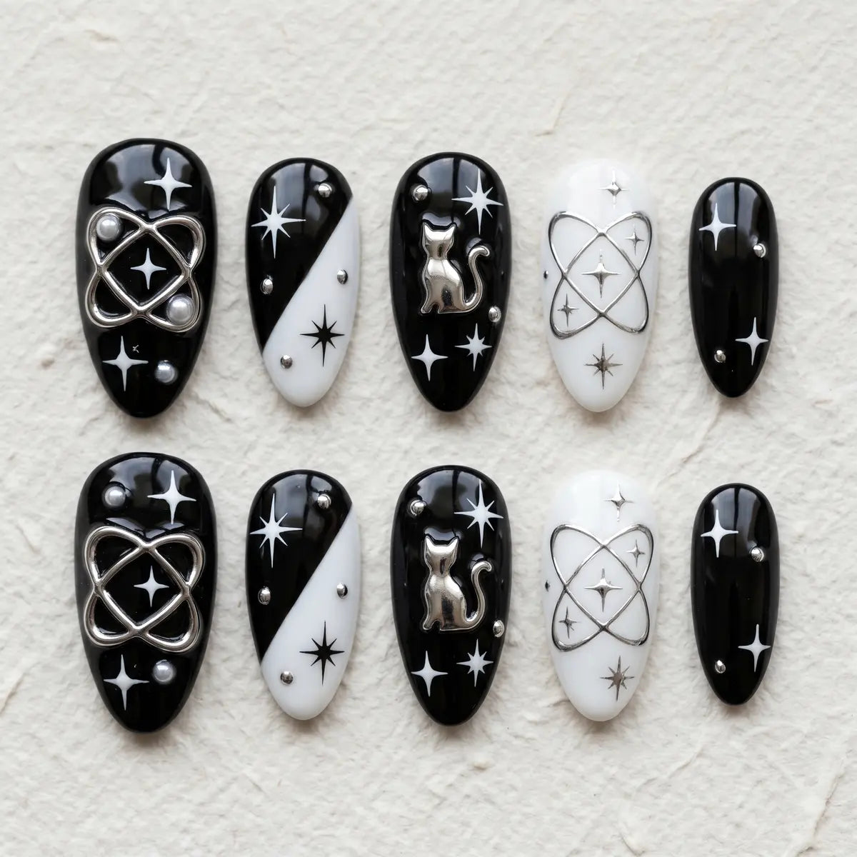 black white 3d almond press on nails goth silver cat planet star flat lay 01