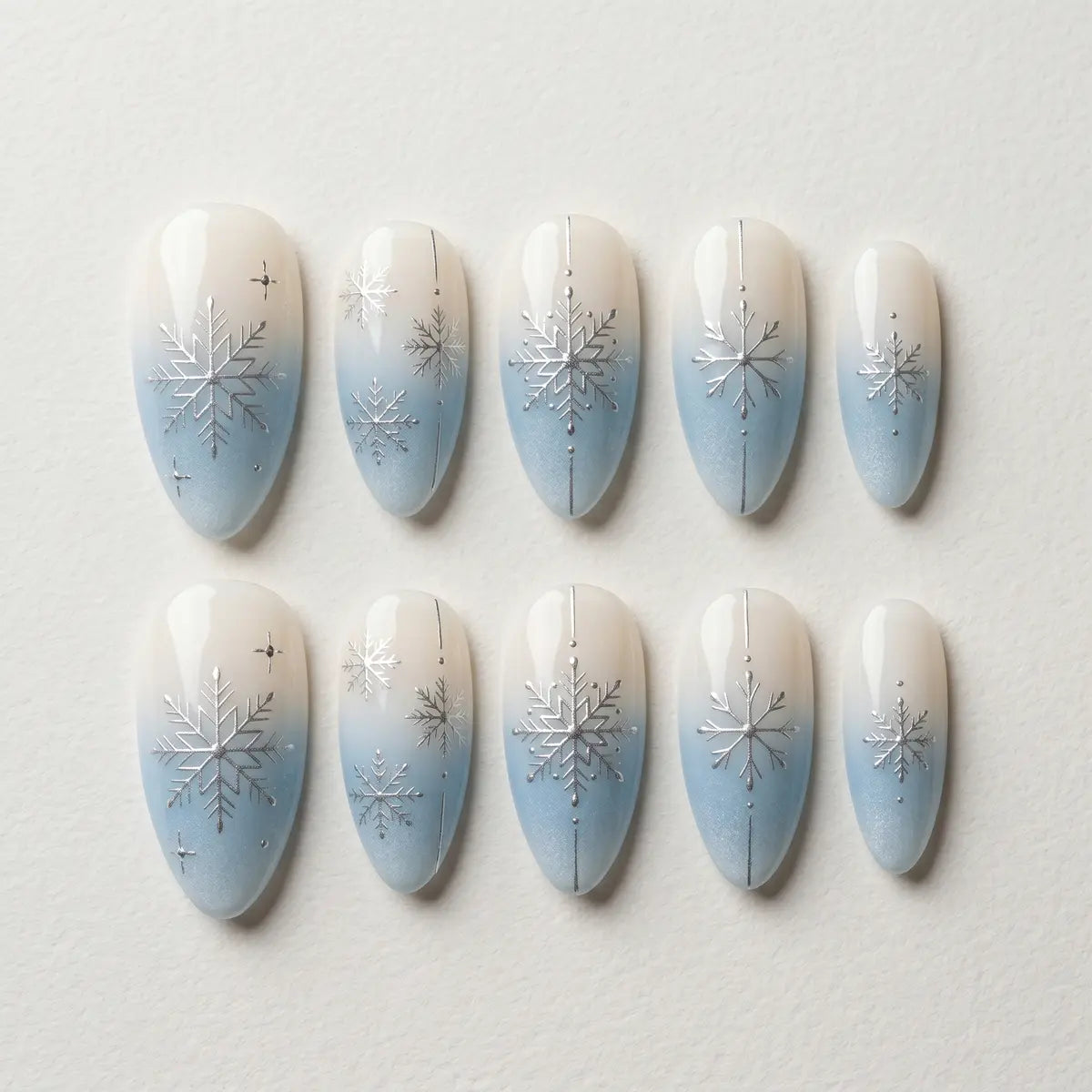 blue white ombre almond press on nails silver snowflake flat lay 04