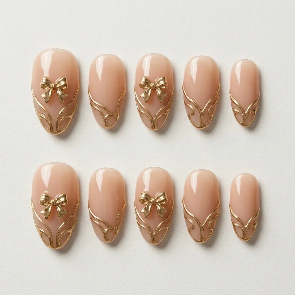 blush nude 3d chrome almond press on nails gold ribbon bow scroll flat lay 04