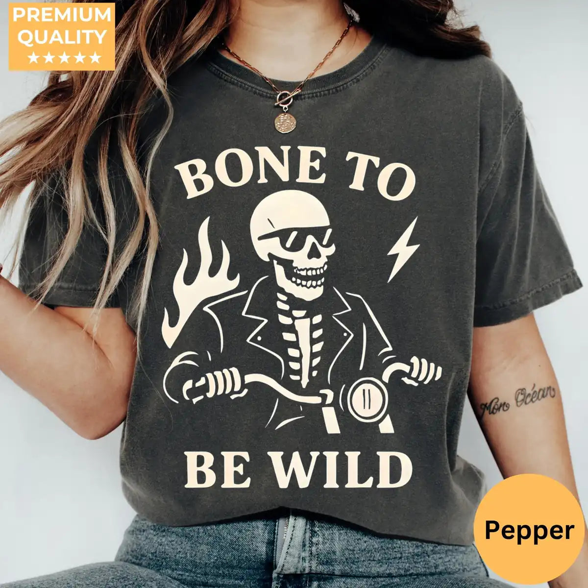 Comfort Colors T-shirt in Pepper color worn by model featuring Bone To Be Wild skeleton riding motorcycle graphic