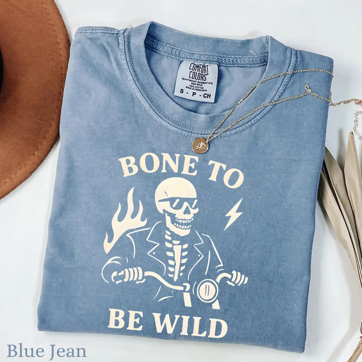 Comfort Colors T-shirt in Moss color featuring Bone To Be Wild skeleton riding motorcycle graphic