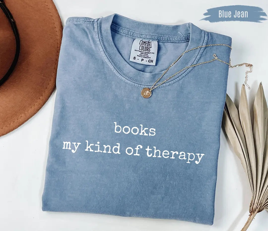 Books Are My Kind Of Therapy graphic Comfort Colors T-shirt in Blue Jean, main product photograph.