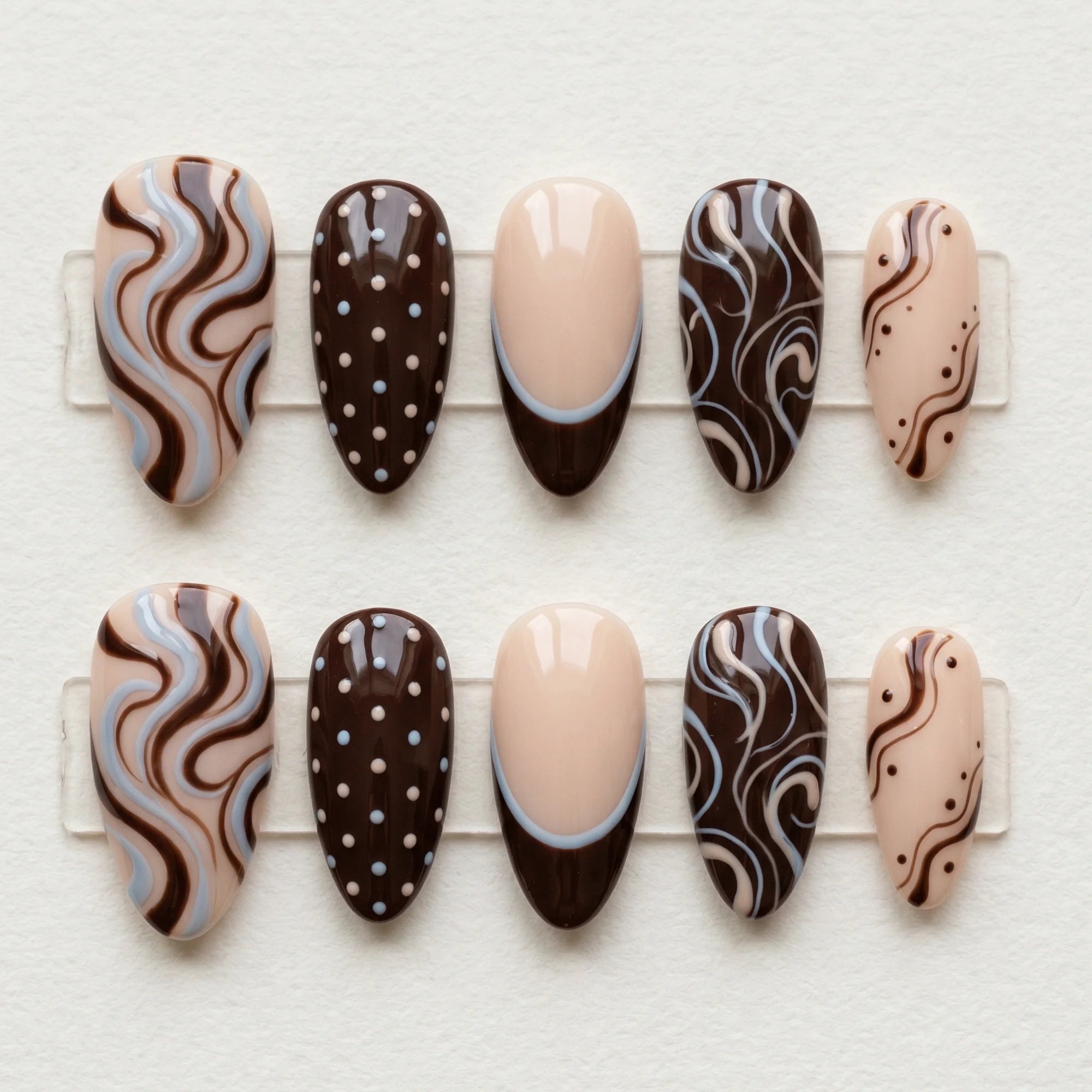 brown hand painted almond medium press on nails swirl polka dot flat lay 01