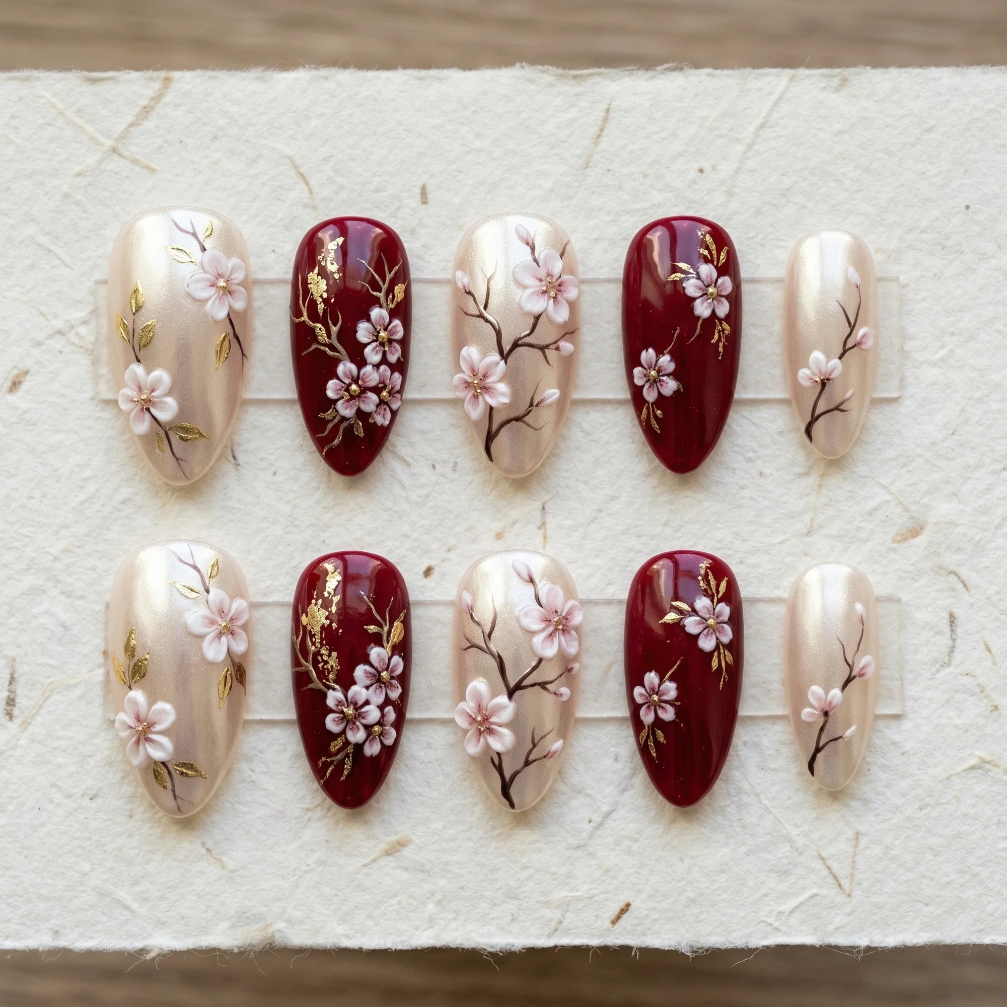 burgundy 3d stiletto medium press on nails sakura blossom flat lay 01