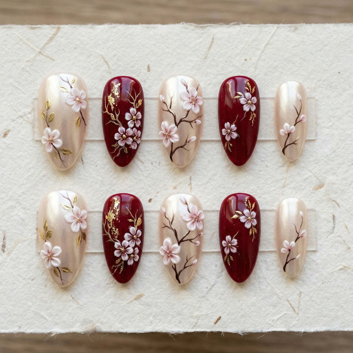 burgundy 3d stiletto medium press on nails sakura blossom flat lay 01