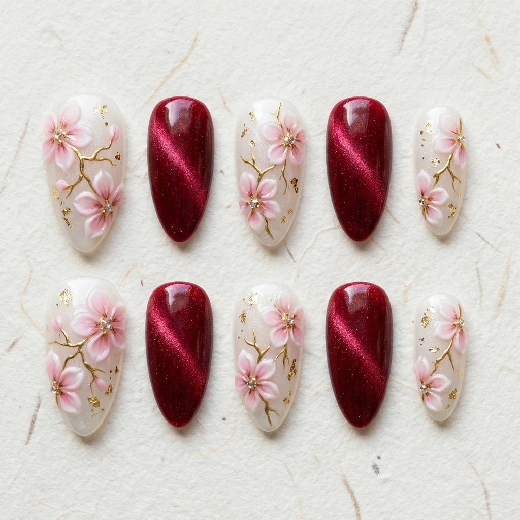 burgundy cat eye hand painted stiletto medium press on nails pink sakura flat lay 01
