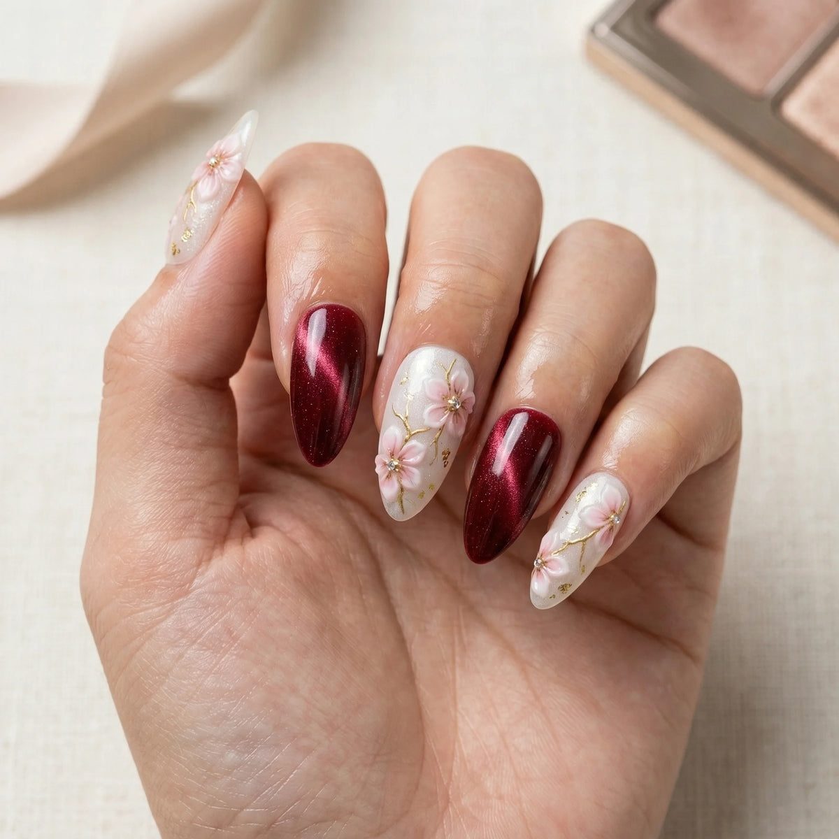 burgundy cat eye hand painted stiletto medium press on nails pink sakura lifestyle 02