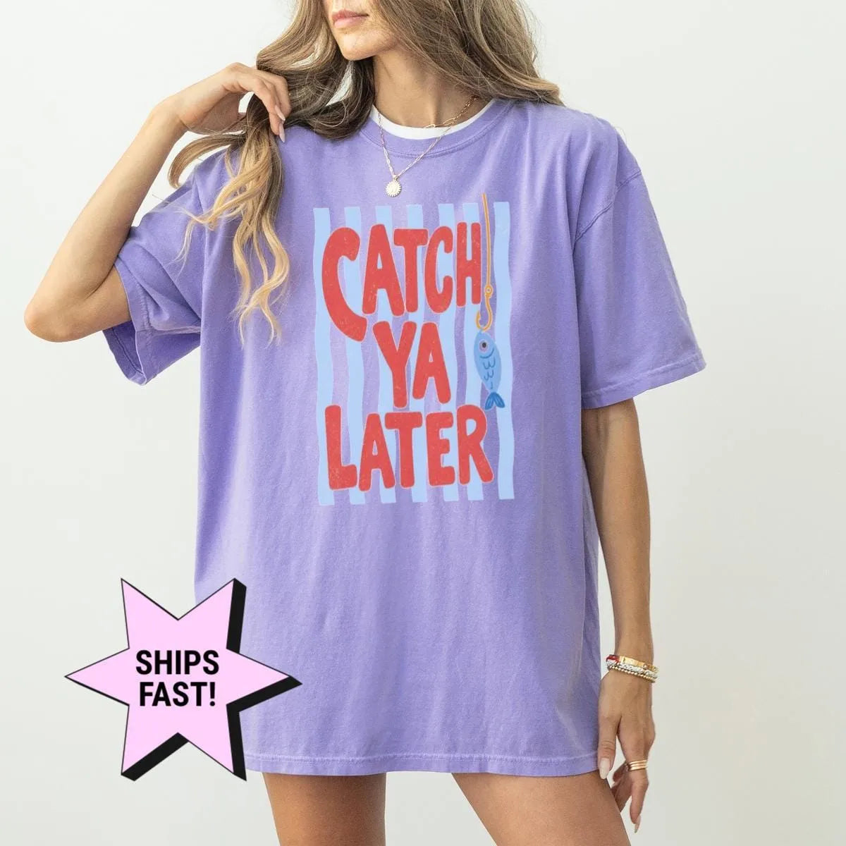 Woman in a Violet Comfort Colors tee with red catch ya later lettering on a pale blue striped panel