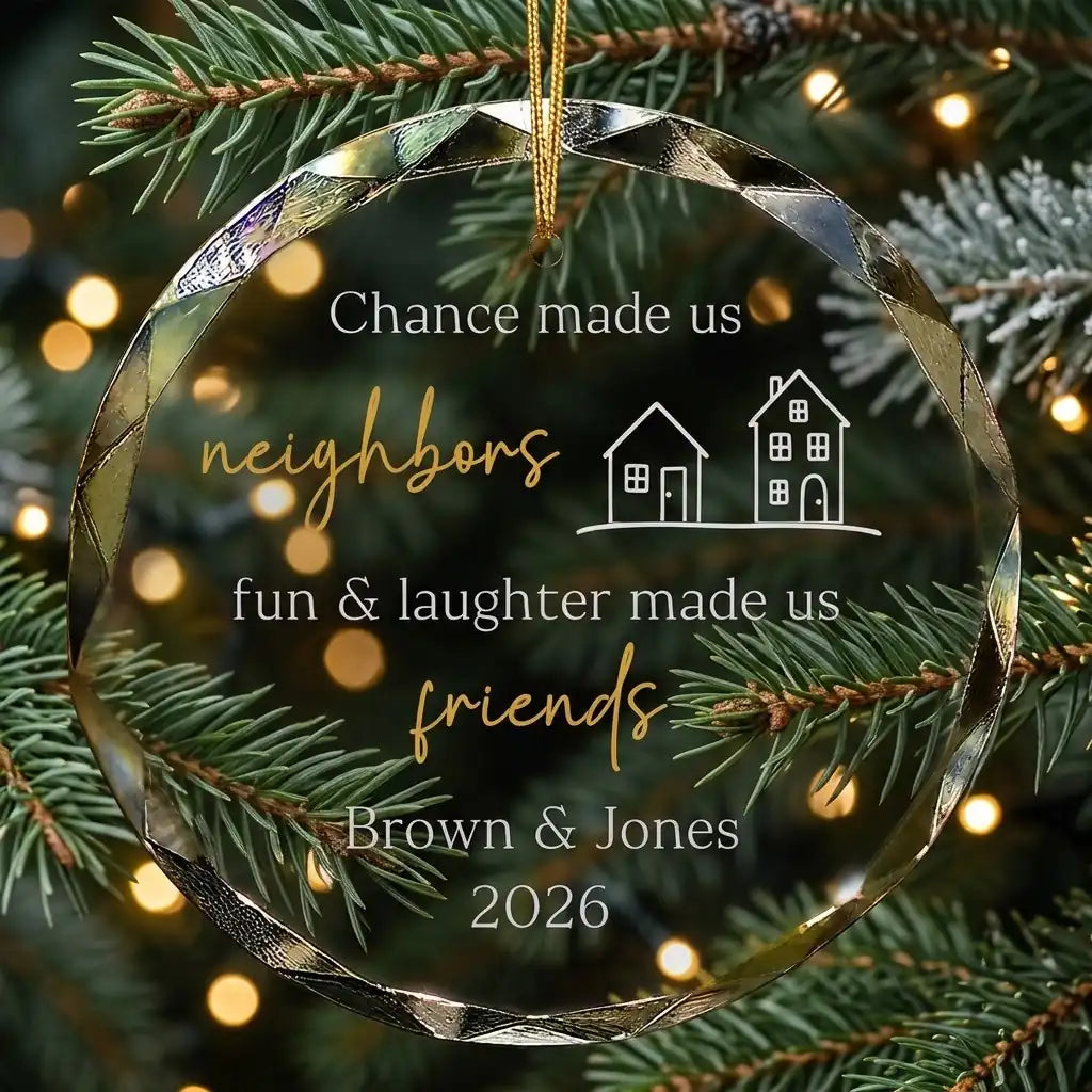 Personalized clear glass neighbor friendship ornament displayed hanging on Christmas tree branch with warm sparkling holiday lights background