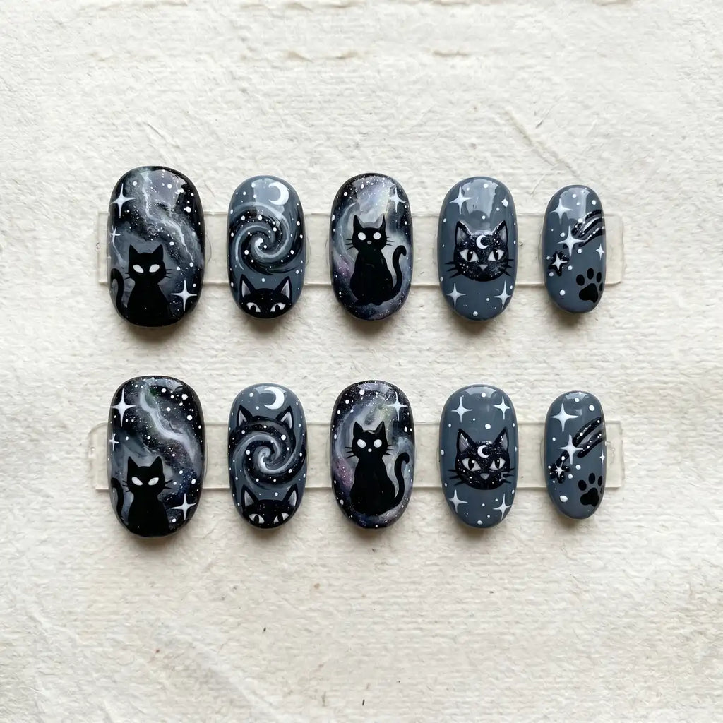 charcoal grey hand painted oval short press on nails galaxy cat flat lay 01