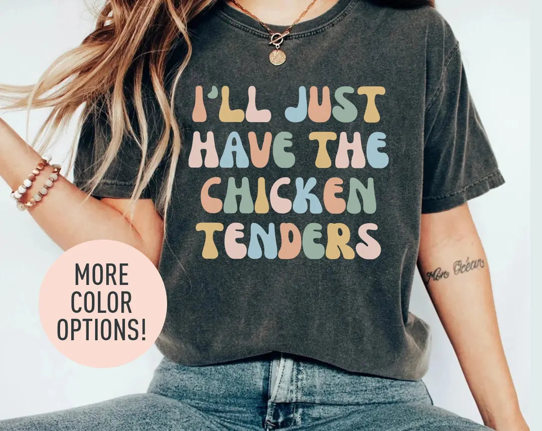 Woman in a dark gray Comfort Colors tee and jeans, bracelets, with i'll just have the chicken tenders in pastel type