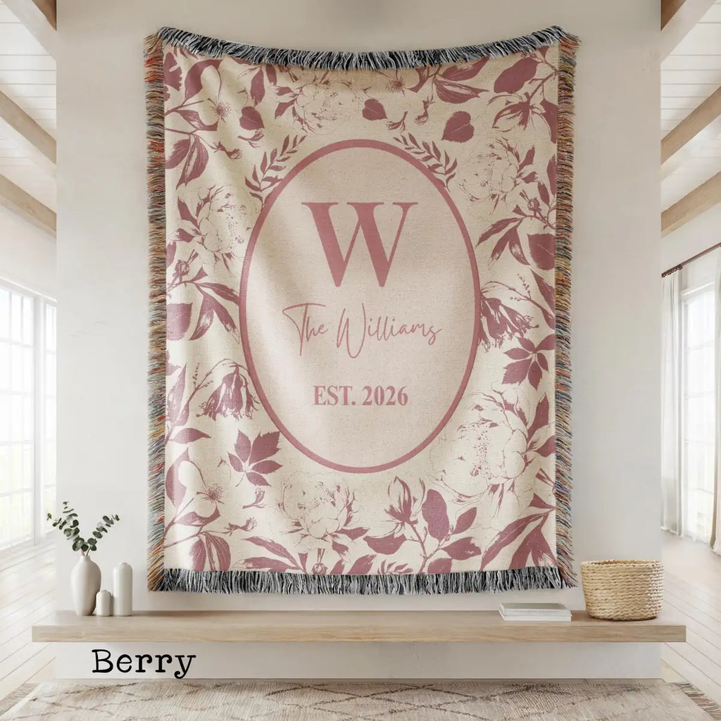 Close-up of the personalized chinoiserie floral toile woven blanket with monogram and fringe detail