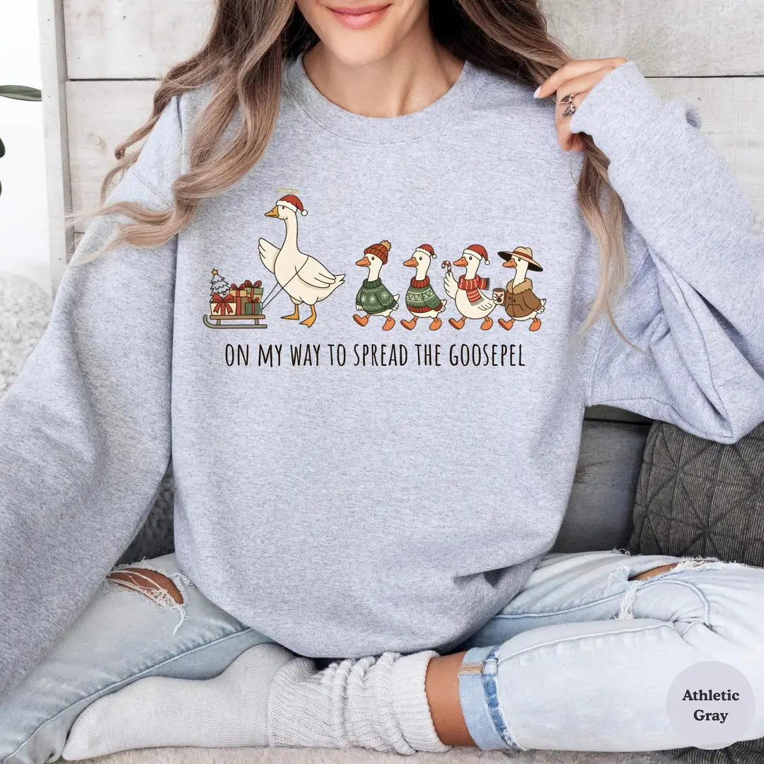 Christian Christmas Goose crewneck sweatshirt on a model in Athletic Gray.