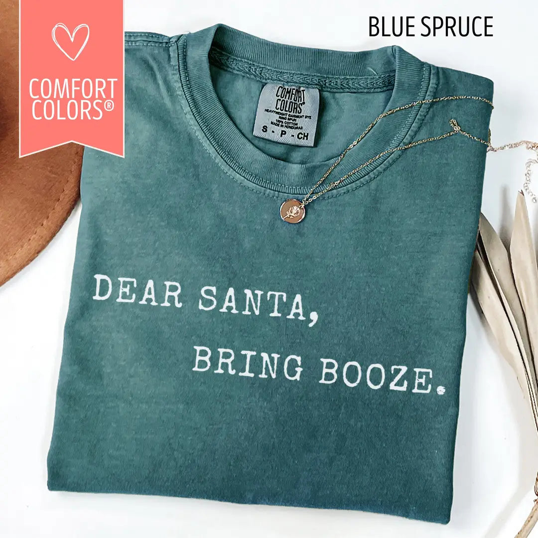 Dear Santa Bring Booze Christmas Comfort Colors 1717 T-shirt folded in Blue Spruce, with white printed lettering.