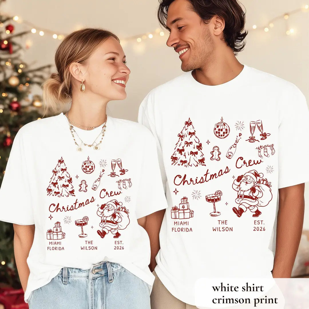 Woman and man by a christmas tree in White Comfort Colors tees, crimson christmas crew, bow tree, santa and Miami Florida