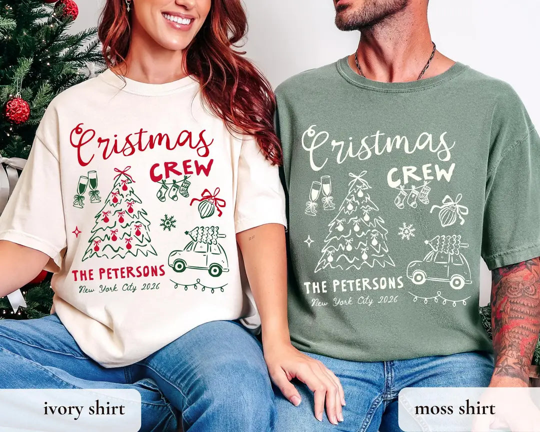 Woman and man in Ivory and Moss Comfort Colors tees by a christmas tree, crew script with a bow tree, car and glasses