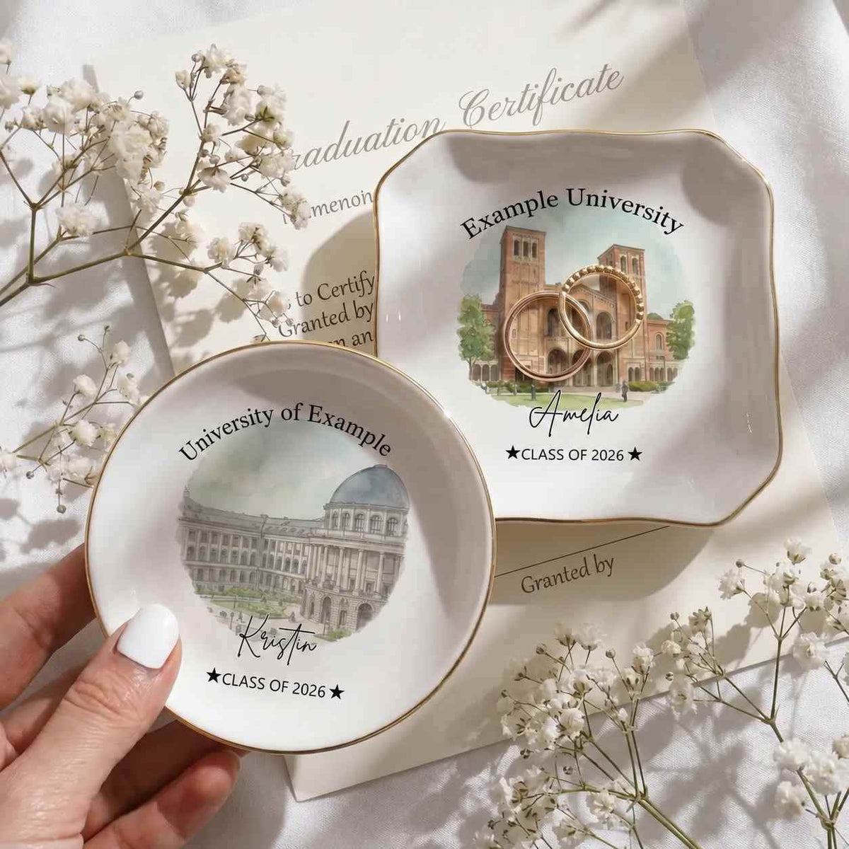 2 different ring dishes displayed on a white table with white flowers. The one on the left is round and the one on the right is wavy-square