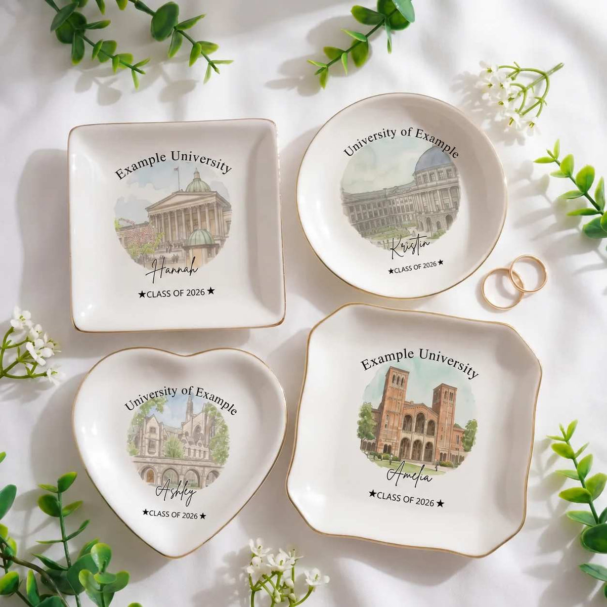 Four different photo-graduation ring dish displayed elegantly on a white table. Each ring dish has different shape.