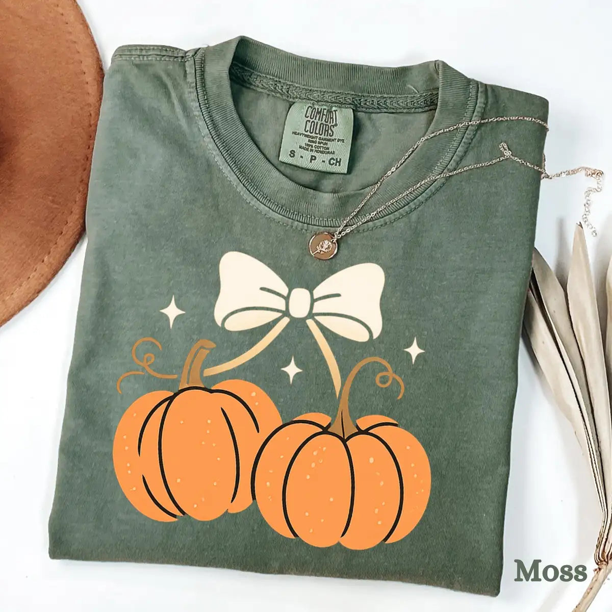 Comfort Colors T-shirt in Moss color featuring coquette pumpkins tied with ribbon bow graphic