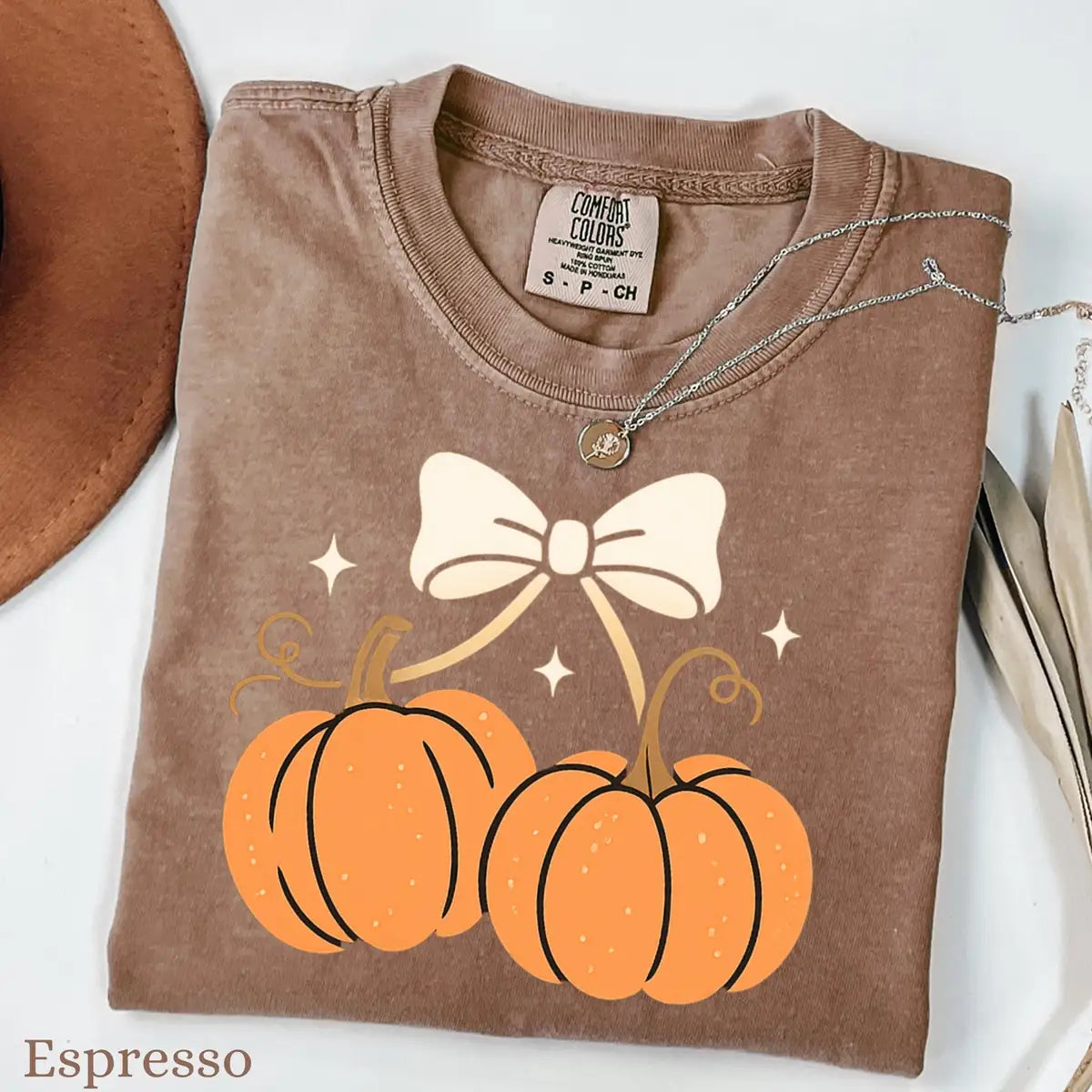 Comfort Colors T-shirt in Yam color featuring pumpkins with bow graphic