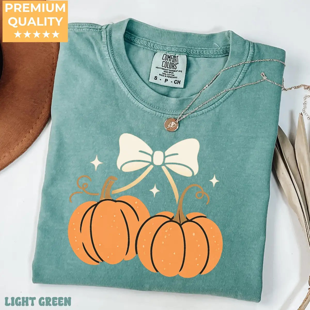 Comfort Colors T-shirt in Crunchberry color featuring pumpkins with bow graphic